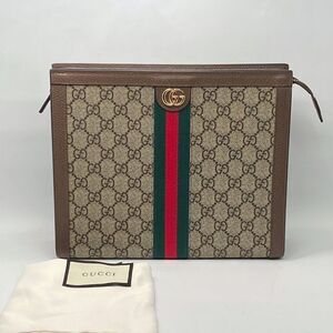 Gucci GG Supreme Fabric clutch with iconic Web Band
